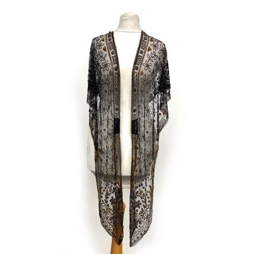 1948 - A 1920s beaded lace shawl, with gold and silver metallic beads in foliate and floral patterns with g... 