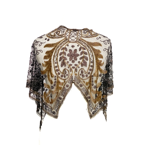 1948 - A 1920s beaded lace shawl, with gold and silver metallic beads in foliate and floral patterns with g...