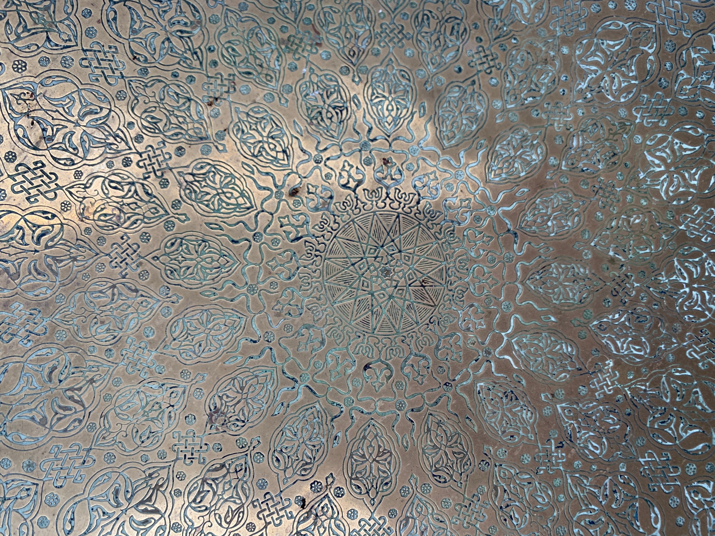 A large 19th century engraved Islamic brass charger, 58cmD