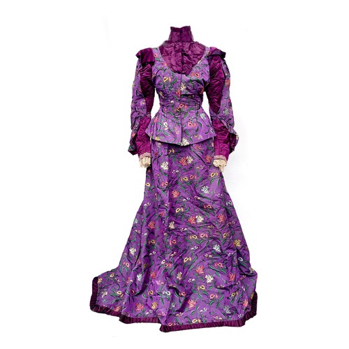 A Victorian purple floral silk jacket and matching skirt, heavily embroidered with parrot tulips, convolvulus and other flowers, the high collar jacket approx 30" bust, 26" waist, the skirt approx 113cmL