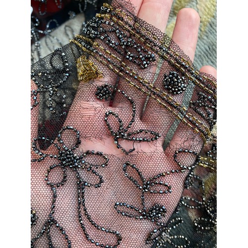 1948 - A 1920s beaded lace shawl, with gold and silver metallic beads in foliate and floral patterns with g... 