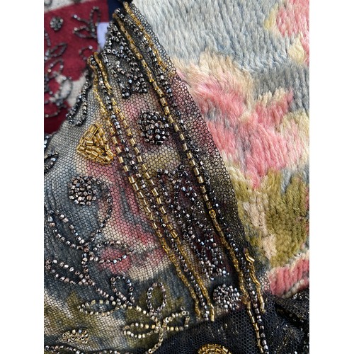 1948 - A 1920s beaded lace shawl, with gold and silver metallic beads in foliate and floral patterns with g... 