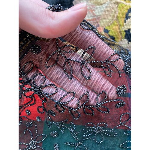1948 - A 1920s beaded lace shawl, with gold and silver metallic beads in foliate and floral patterns with g... 