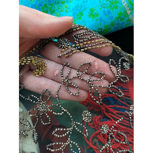 1948 - A 1920s beaded lace shawl, with gold and silver metallic beads in foliate and floral patterns with g... 