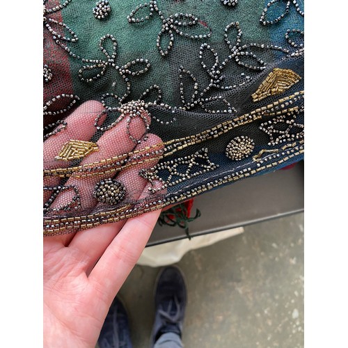 1948 - A 1920s beaded lace shawl, with gold and silver metallic beads in foliate and floral patterns with g... 