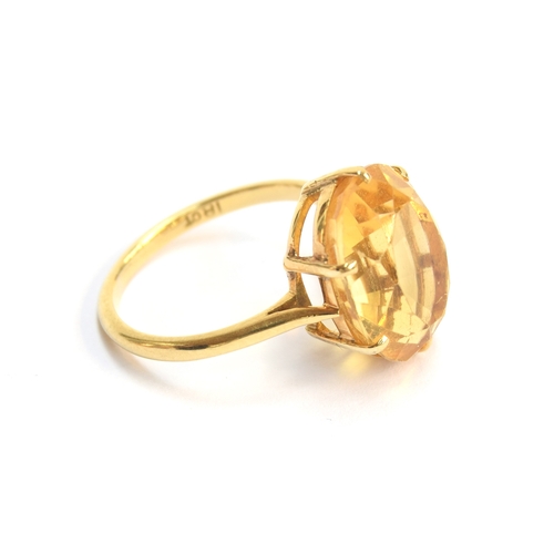 18 - An 18ct gold and citrine solitaire ring, the citrine 14.5x11mm, size L, 3.8g