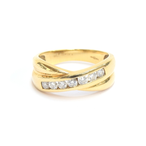 21 - An 18ct gold and diamond crossover ring, size M, 4.5g