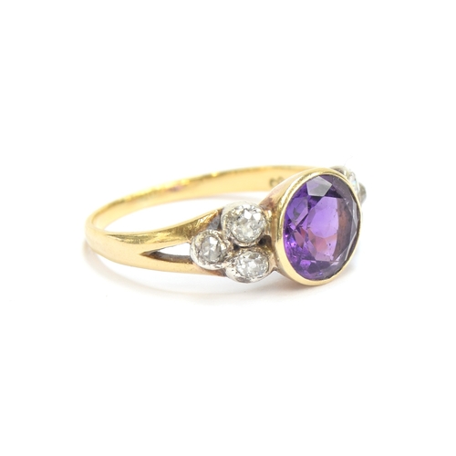 10 - An early 20th century 18ct gold, amethyst and diamond ring, the bezel mounted central stone 8mm wide... 