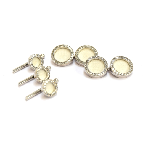 28 - A set of Cartier platinum and diamond cufflinks and studs, each link set with a white biscuit porcel... 