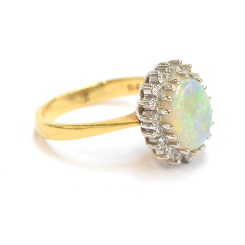 17 - An 18ct yellow gold, opal, and diamond cluster ring, the opal 9x7.5mm, size M, 5.1g