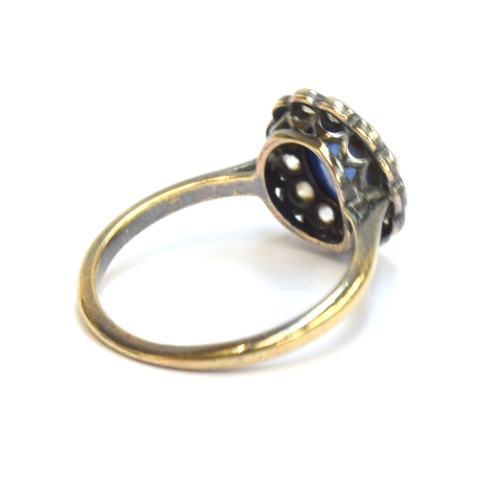 24 - An early 20th century 18ct gold, sapphire cabochon and diamond cluster ring, the sapphire measuring ... 