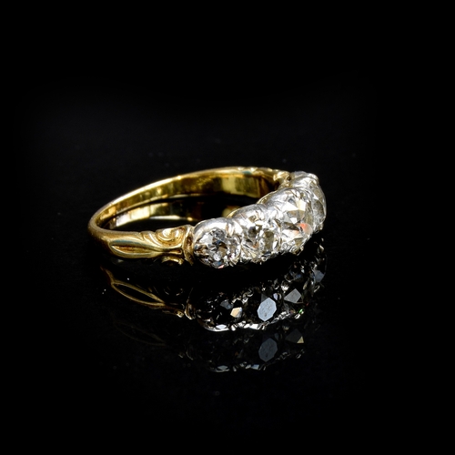 25 - A Victorian 18ct gold and diamond five stone ring, the open backed diamonds in cut down silver colle... 