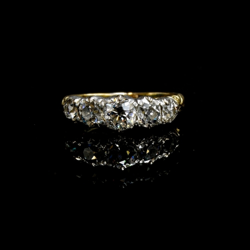25 - A Victorian 18ct gold and diamond five stone ring, the open backed diamonds in cut down silver colle... 