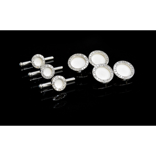 28 - A set of Cartier platinum and diamond cufflinks and studs, each link set with a white biscuit porcel... 