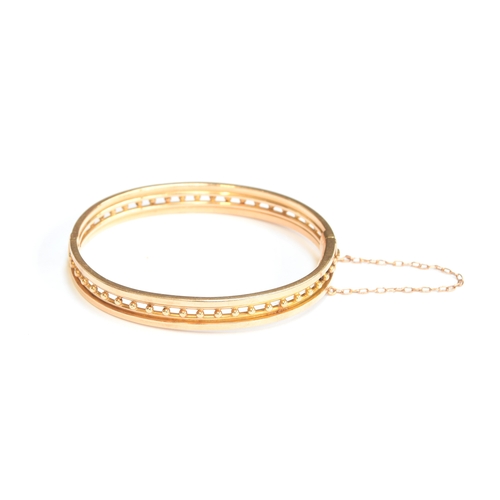 41 - A late 19th/early 20th century 15ct gold bangle, the clasp tongue stamped '15', 6.1cm wide, 12.5g