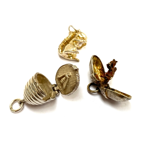 37 - Three silver charms, a squirrel, beehive and acorn opening to reveal a squirrel, gross weight 10.7g