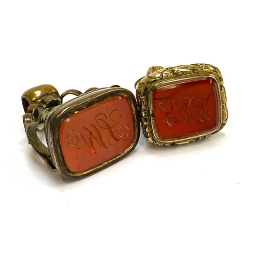 58 - Two Georgian gilt metal fob seals with carnelian intaglios engraved with initials 'MI' and 'HMM', th... 
