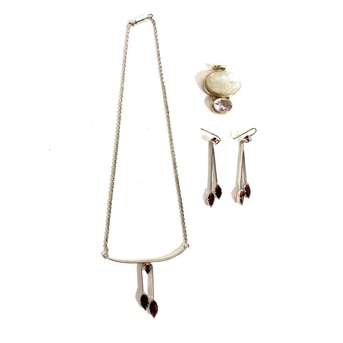 122 - A 925 silver mounted moonstone and quartz pendant; together with a pair of silver plated garnet drop... 