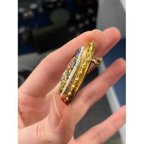 53 - An early 20th century gold mounted micro mosaic brooch/pendant, high relief floral bouquet, glazed l... 