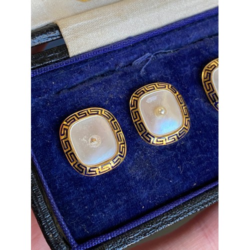 32 - A set of four 18ct gold, enamel, mother of pearl and pearl buttons, the mother of pearl panels surro... 