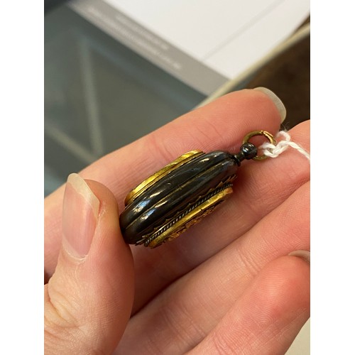 52 - A 19th century Japanese Shakudo locket, with applied silver and gold decoration, one side depicting ... 