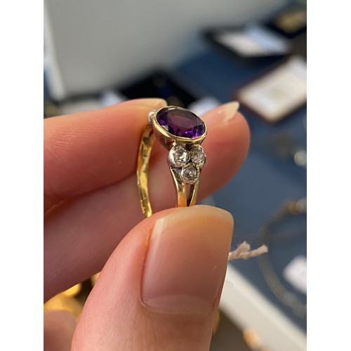 10 - An early 20th century 18ct gold, amethyst and diamond ring, the bezel mounted central stone 8mm wide... 