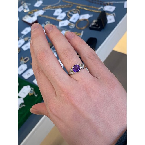 10 - An early 20th century 18ct gold, amethyst and diamond ring, the bezel mounted central stone 8mm wide... 