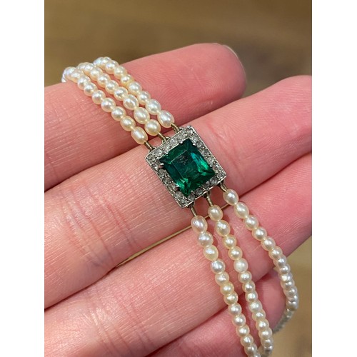 33 - An Edwardian three strand seed pearl bracelet with central rectangular bluish-green tourmaline surro... 