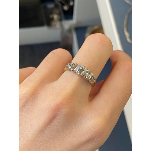 25 - A Victorian 18ct gold and diamond five stone ring, the open backed diamonds in cut down silver colle... 