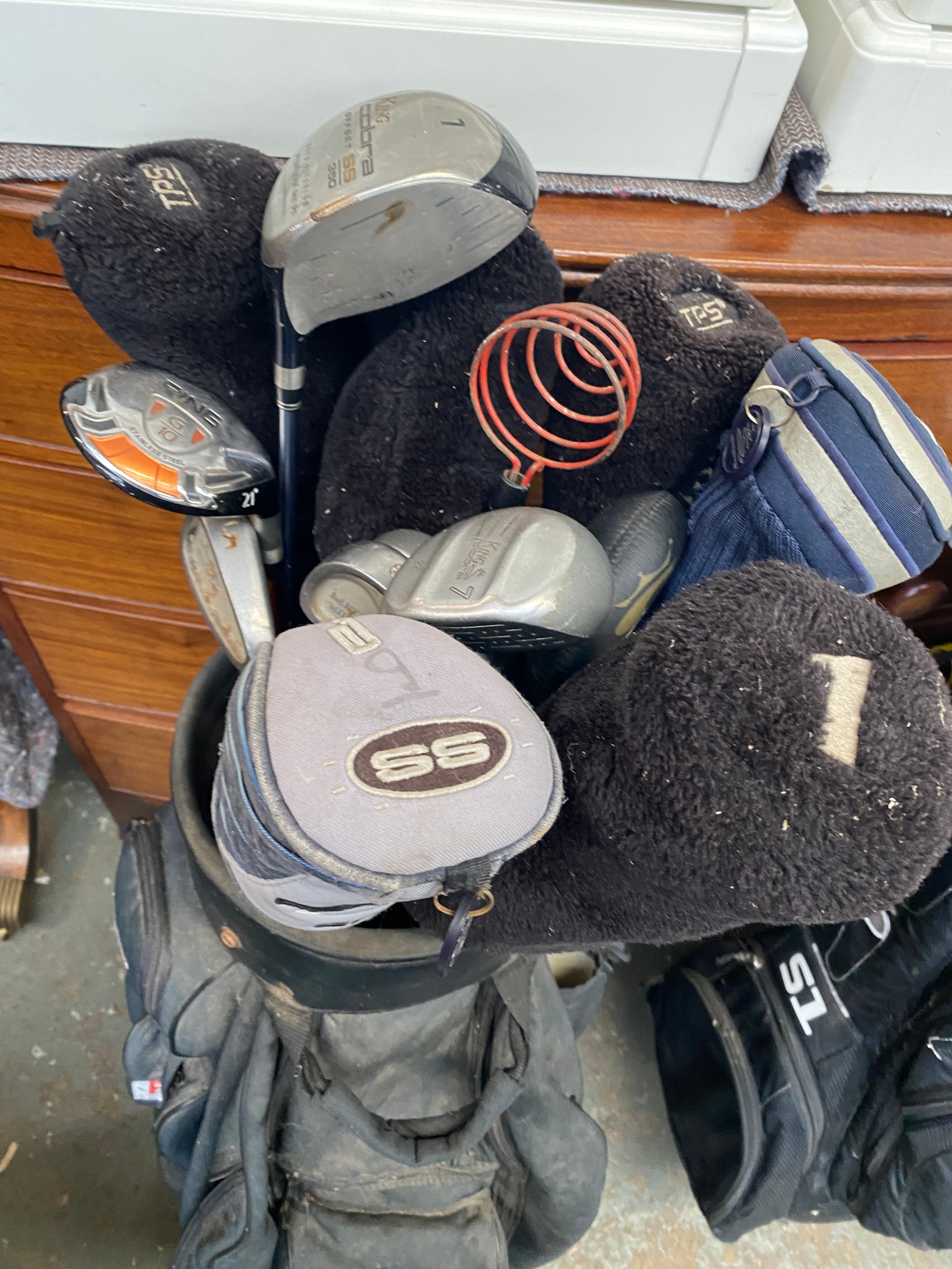 A Masters golf club holder containing a number of clubs to include King ...