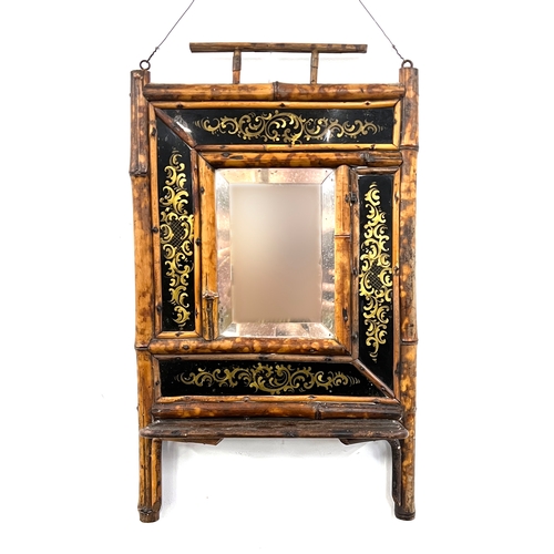 761 - A tiger bamboo hall mirror, with bevelled plate, surrounded by verre eglomise panels, shelf below, 2... 