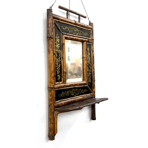 761 - A tiger bamboo hall mirror, with bevelled plate, surrounded by verre eglomise panels, shelf below, 2... 