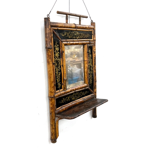 761 - A tiger bamboo hall mirror, with bevelled plate, surrounded by verre eglomise panels, shelf below, 2... 