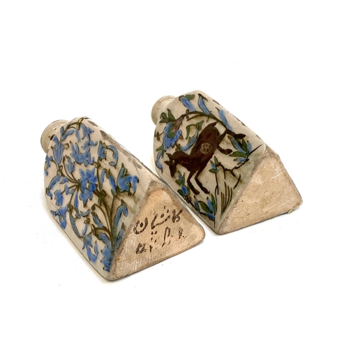 192 - A pair of Persian Qajar Iznik style tri-sided pottery vases, one decorated with a youth and horse, t... 