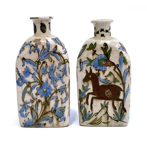 192 - A pair of Persian Qajar Iznik style tri-sided pottery vases, one decorated with a youth and horse, t... 