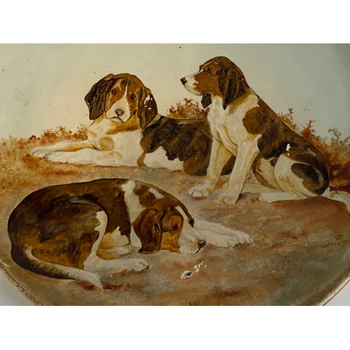 205 - Two early 20th century chargers hand painted with whippets and beagles, 36cmD