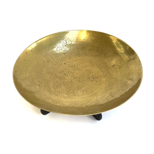 428 - A large early 20th century Chinese brass charger engraved with dragons, on a carved wooden stand wit... 