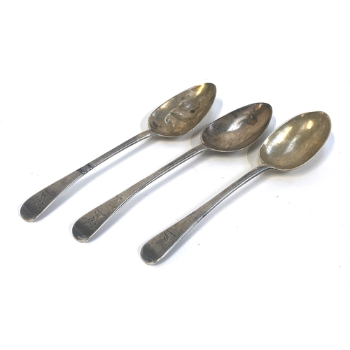 74 - A pair of Georgian silver Old English pattern table spoons, one af, together with one other later, a... 