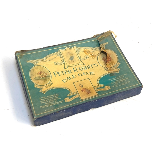 445 - An early 20th century Peter Rabbit's Race Game, boxed, with fold-out board and cast metal character ... 
