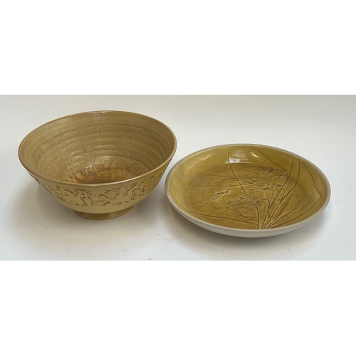 259 - A large stoneware fruit bowl decorated with a band of people in relief, signed Umtali to base, 33cmD... 