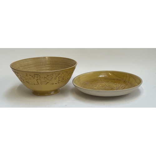 259 - A large stoneware fruit bowl decorated with a band of people in relief, signed Umtali to base, 33cmD... 