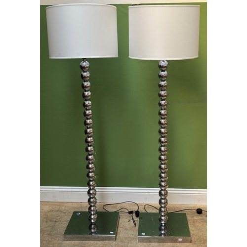 1082 - A pair of contemporary chromed 'bobbin' standard lamps, each with large white cylindrical shade, 136... 