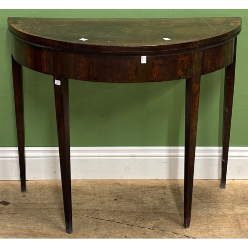 1312 - A George III mahogany demilune card table, the lining missing
