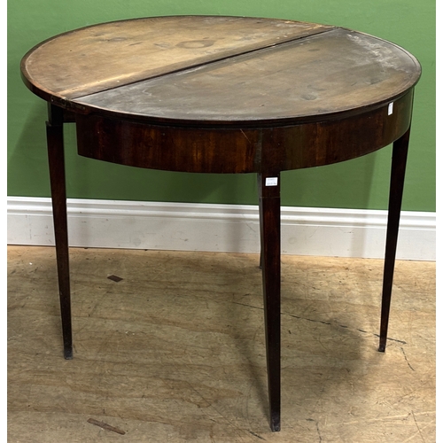 1312 - A George III mahogany demilune card table, the lining missing