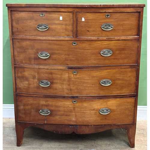 1051 - An early 19th century bowfront mahogany chest of two short over three long drawers, on bracket feet,... 