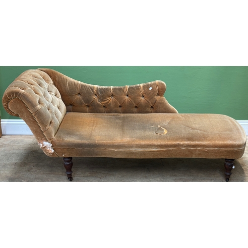1332 - A button upholstered chaise longue, on turned legs and casters, in need of reupholstery, approx. 170... 