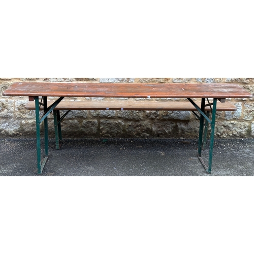 1353 - A narrow pine trestle table, on folding green metal base, 216x50x76cm; together with one matching fo... 