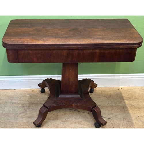 1284 - An early 19th century mahogany tea table, fold over top on tapering square column and quatrefoil bas... 