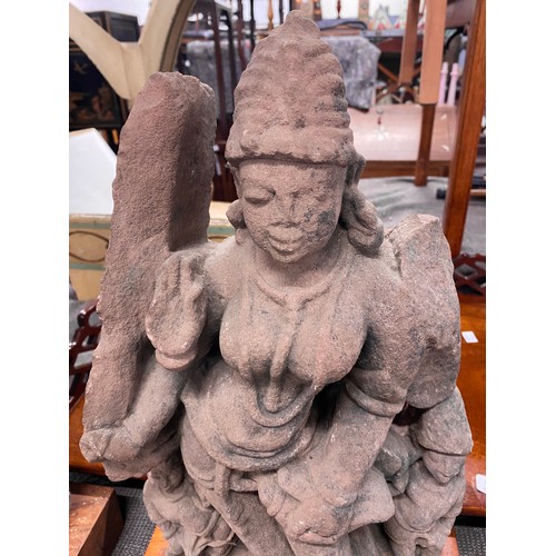 1240 - An Indian carved sandstone statue depicting the god Surya flanked by diminutive attendants, 47cmH ex... 