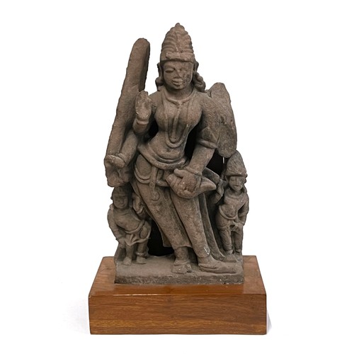 1240 - An Indian carved sandstone statue depicting the god Surya flanked by diminutive attendants, 47cmH ex... 